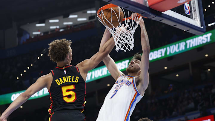 Oct 27, 2024; Oklahoma City, Oklahoma, USA; Oklahoma City Thunder center Chet Holmgren (7) dunks in front of Atlanta Hawks guard Dyson Daniels (5) during the second half at Paycom Center. Mandatory Credit: Alonzo Adams-Imagn Images