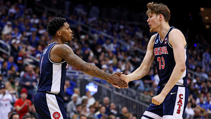 Arizona Wildcats guard Caleb Love (1) and forward Henri Veesaar (13) react during the first half against the Duke Blue Devils during an East Regional semifinal of the 2025 NCAA tournament at Prudential Center.