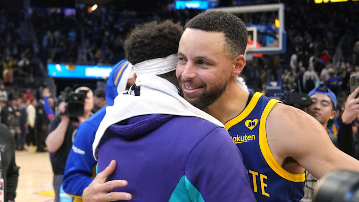 Feb 23, 2024; San Francisco, California, USA; Golden State Warriors guard Stephen Curry (right) hugs Charlotte Hornets guard Seth Curry (left) after the game at Chase Center. Mandatory Credit: Darren Yamashita-Imagn Images