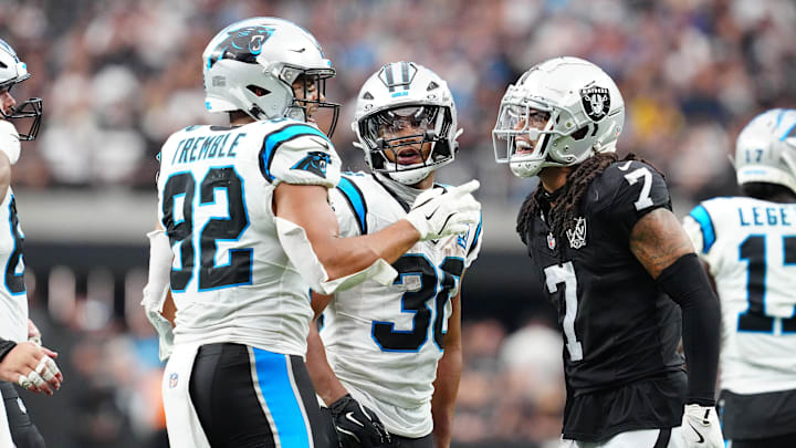 Sep 22, 2024; Paradise, Nevada, USA; Las Vegas Raiders safety Tre'von Moehrig (7) has words with Carolina Panthers tight end Tommy Tremble (82) and Las Vegas Raiders cornerback Darnay Holmes (30) during the fourth quarter at Allegiant Stadium. Mandatory Credit: Stephen R. Sylvanie-Imagn Images