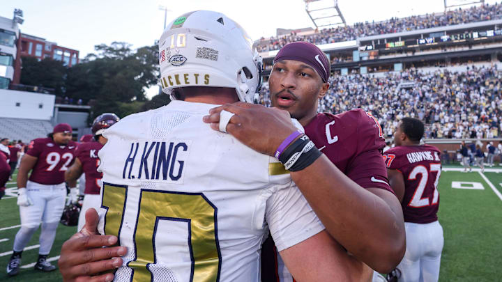 Oct 11, 2025; Atlanta, Georgia, USA; Georgia Tech Yellow Jackets quarterback Haynes King (10) talks to Virginia Tech Hokies quarterback Kyron Drones (1) after a game at Bobby Dodd Stadium at Hyundai Field. Mandatory Credit: Brett Davis-Imagn Images
Oct 11, 2025; Atlanta, Georgia, USA; Georgia Tech Yellow Jackets quarterback Haynes King (10) talks to Virginia Tech Hokies quarterback Kyron Drones (1) after a game at Bobby Dodd Stadium at Hyundai Field. Mandatory Credit: Brett Davis-Imagn Images