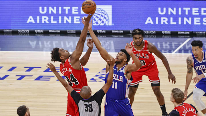 Mar 11, 2021; Chicago, Illinois, USA; Chicago Bulls center Wendell Carter Jr. (34) and Philadelphia 76ers center Tony Bradley (11) battle for the ball at the tip-off at United Center. Mandatory Credit: Kamil Krzaczynski-Imagn Images