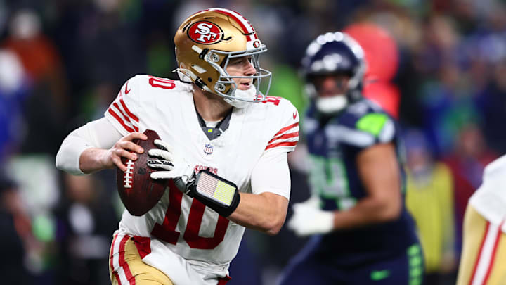 Jan 17, 2026; Seattle, WA, USA; San Francisco 49ers quarterback Mac Jones (10) rolls out against the Seattle Seahawks during the second half in an NFC Divisional Round game at Lumen Field. Mandatory Credit: Kevin Ng-Imagn Images