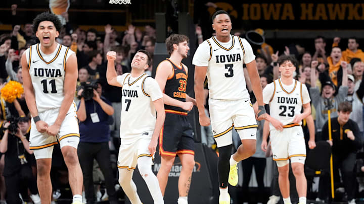 Iowa’s Kael Combs (11), Alvaro Folgueiras (7), Cam Manyawu (3) and Isaia Howard (23) react as the Hawkeyes survive against the USC Trojans Jan. 28, 2026 at Carver-Hawkeye Arena in Iowa City, Iowa.