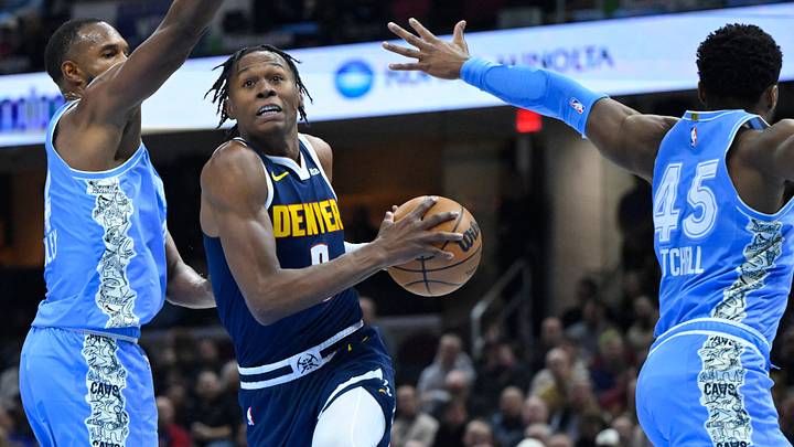 Dec 5, 2024; Cleveland, Ohio, USA; Denver Nuggets forward Peyton Watson (8) drives between Cleveland Cavaliers forward Evan Mobley (4) and guard Donovan Mitchell (45) in the second quarter at Rocket Mortgage FieldHouse. Mandatory Credit: David Richard-Imagn Images Dec 5, 2024; Cleveland, Ohio, USA; Denver Nuggets forward Peyton Watson (8) drives between Cleveland Cavaliers forward Evan Mobley (4) and guard Donovan Mitchell (45) in the second quarter at Rocket Mortgage FieldHouse. Mandatory Credit: David Richard-Imagn Images