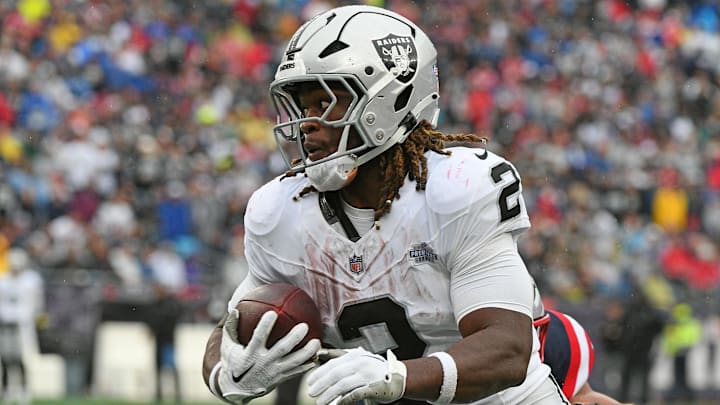 Sep 7, 2025; Foxborough, Massachusetts, USA; Las Vegas Raiders running back Ashton Jeanty (2) rushes the ball against the New England Patriots during the second half at Gillette Stadium. Mandatory Credit: Bob DeChiara-Imagn Images