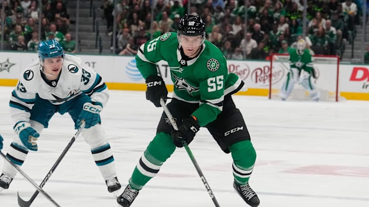Mar 2, 2024; Dallas, Texas, USA;  Dallas Stars defenseman Thomas Harley (55) skates with the puck ahead of San Jose Sharks defenseman Calen Addison (33) during the second period at American Airlines Center. Mandatory Credit: Chris Jones-Imagn Images