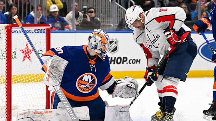 Dec 29, 2023; Elmont, New York, USA; Washington Capitals left wing Alex Ovechkin (8) attempts to put in a rebound on New York Islanders goaltender Ilya Sorokin (30) during the third period at UBS Arena. Mandatory Credit: Dennis Schneidler-Imagn Images