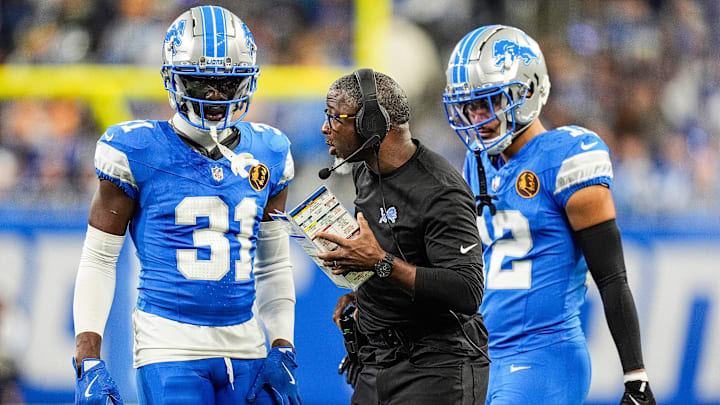Detroit Lions defensive coordinator Aaron Glenn talks to safety Kerby Joseph (31), left, and safety Brian Branch (32) during the first half against Chicago Bears at Ford Field in Detroit on Thursday, Nov. 28, 2024.