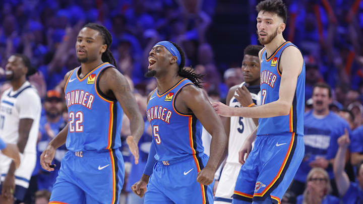 May 22, 2025; Oklahoma City, Oklahoma, USA; Oklahoma City Thunder guard Luguentz Dort (5) celebrates with guard Cason Wallace (22) and forward Chet Holmgren (7) after a play against the Minnesota Timberwolves in the third quarter during game two of the western conference finals for the 2025 NBA Playoffs at Paycom Center. Mandatory Credit: Alonzo Adams-Imagn Images