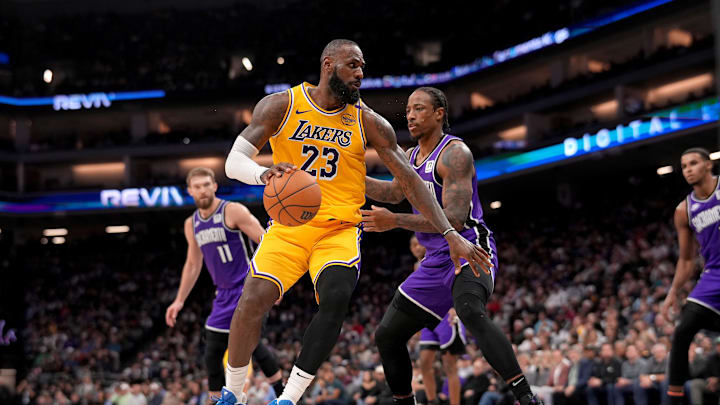 Dec 19, 2024; Sacramento, California, USA; Los Angeles Lakers forward LeBron James (23) dribbles the ball next to Sacramento Kings guard DeMar DeRozan (10) in the first quarter at the Golden 1 Center. Mandatory Credit: Cary Edmondson-Imagn Images