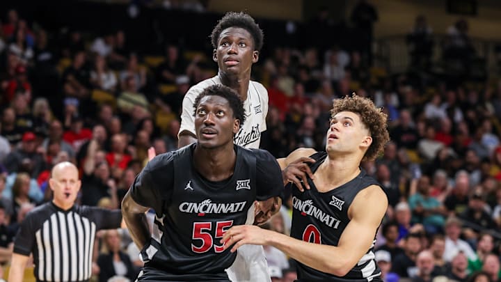Feb 5, 2025; Orlando, Florida, USA; Cincinnati Bearcats forward Aziz Bandaogo (55), guard Dan Skillings Jr. (0) and UCF Knights center Moustapha Thiam (52) during the second half at Addition Financial Arena. Mandatory Credit: Mike Watters-Imagn Images