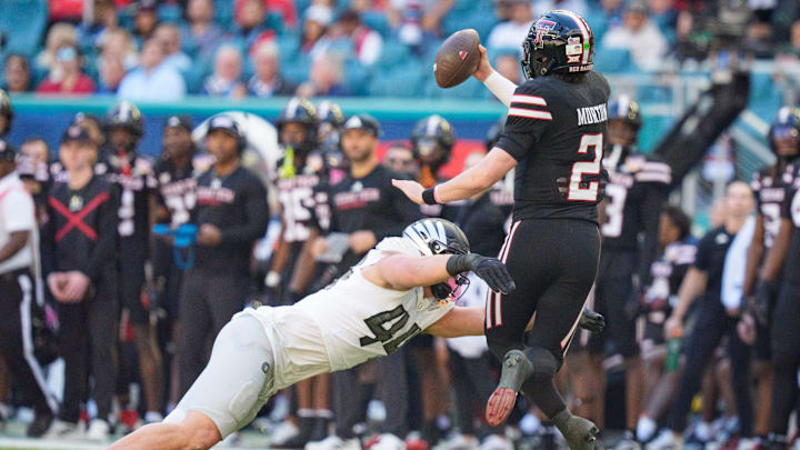 Oregon outside linebacker Teitum Tuioti, left, sacks Texas Tech quarterback Behren Morton as the Oregon Ducks take on the Texas Tech Red Raiders in the Orange Bowl on Jan. 1, 2026, at Hard Rock Stadium in Miami, Florida.