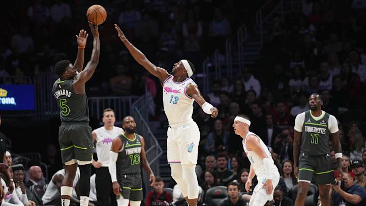Mar 7, 2025; Miami, Florida, USA;  Minnesota Timberwolves guard Anthony Edwards (5) shoots over Miami Heat center Bam Adebayo (13) during the first half at Kaseya Center. Mandatory Credit: Jim Rassol-Imagn Images