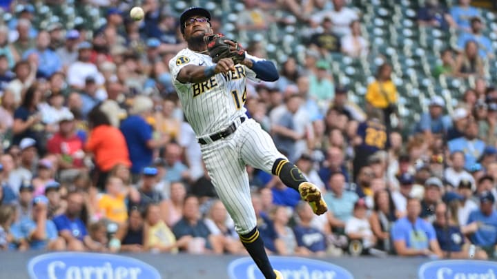 Aug 5, 2023; Milwaukee, Wisconsin, USA;  Milwaukee Brewers third baseman Andruw Monasterio (14) throws out Pittsburgh Pirates designated hitter Andrew McCutchen (22) in the fourth inning at American Family Field. Mandatory Credit: Benny Sieu-Imagn Images