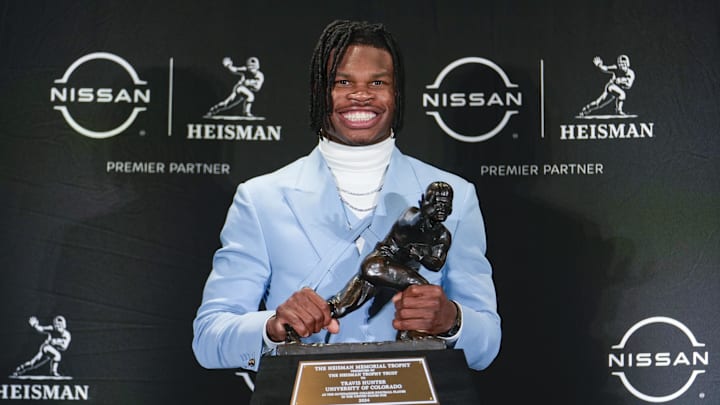 Dec 14, 2024; New York, NY, USA; Colorado Buffaloes wide receiver/cornerback Travis Hunter poses for a photo after winning the Heisman Trophy award during the 2024 Heisman Trophy Presentation.  