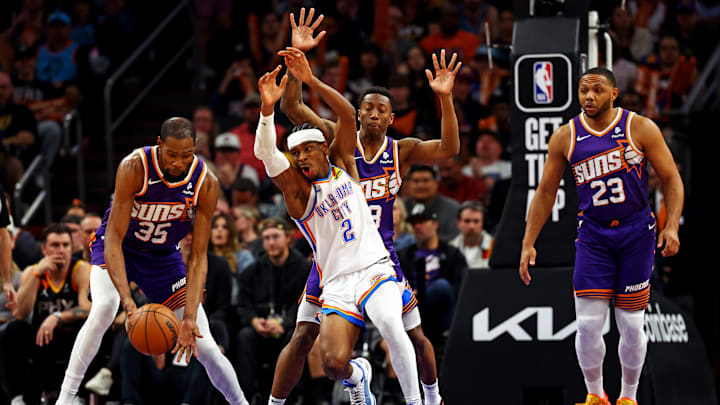 Mar 3, 2024; Phoenix, Arizona, USA; Phoenix Suns forward Kevin Durant (35) and Oklahoma City Thunder guard Shai Gilgeous-Alexander (2) go for the ball during the third quarter at Footprint Center. Mandatory Credit: Mark J. Rebilas-Imagn Images