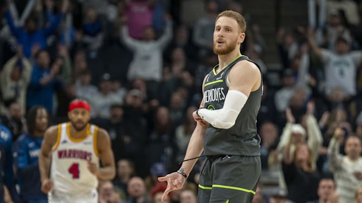 Jan 15, 2025; Minneapolis, Minnesota, USA; Minnesota Timberwolves guard Donte DiVincenzo (0) celebrates after making a three point shot against the Golden State Warriors at Target Center. Mandatory Credit: Jesse Johnson-Imagn Images