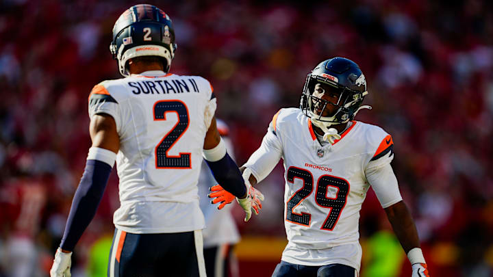 Denver Broncos cornerback Ja'Quan McMillian (29) celebrates with cornerback Pat Surtain II (2) after a play during the second half against the Kansas City Chiefs at GEHA Field at Arrowhead Stadium.