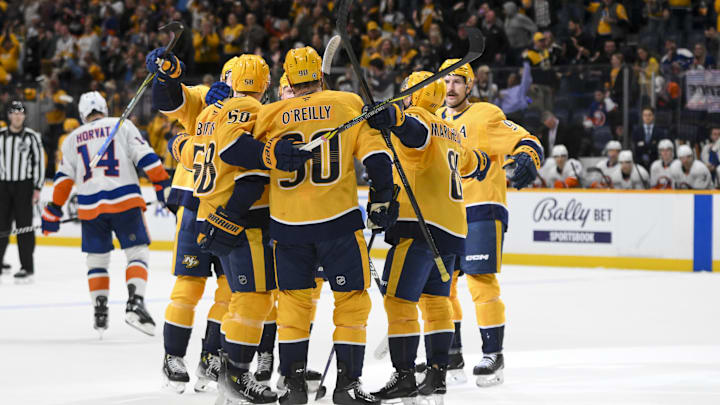 Apr 8, 2025; Nashville, Tennessee, USA;  Nashville Predators left wing Michael Bunting (58) celebrates his goal with his teammates  on the tying deflection from the shot of center Steven Stamkos (91) against the New York Islanders during the third period at Bridgestone Arena. Mandatory Credit: Steve Roberts-Imagn Images