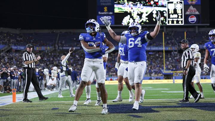 Dec 27, 2025; Orlando, FL, USA; BYU Cougars running back Jovesa Damuni (28) reacts after scoring a touchdown against the Georgia Tech Yellow Jackets in the fourth quarter during the Pop-Tarts Bowl at Camping World Stadium. Mandatory Credit: Nathan Ray Seebeck-Imagn Images