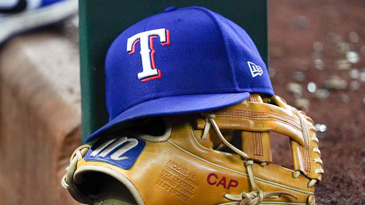 Apr 28, 2025; Arlington, Texas, USA; A Texas Rangers cap and baseball mitt sit on the dugout steps during a game against the Athletics at Globe Life Field. Apr 28, 2025; Arlington, Texas, USA; A Texas Rangers cap and baseball mitt sit on the dugout steps during a game against the Athletics at Globe Life Field.