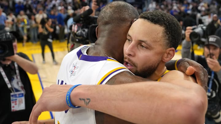 Dec 25, 2024; San Francisco, California, USA; Golden State Warriors guard Stephen Curry (center right) greets Los Angeles Lakers forward LeBron James (center left) after the game at Chase Center. Mandatory Credit: Darren Yamashita-Imagn Images