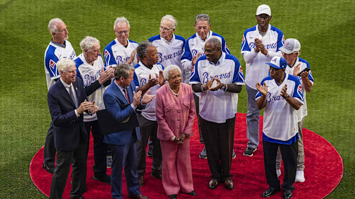 Billye Aaron, the widow of Atlanta Braves hall of fame player Hank Aaron, on the field with Georgia governor Brian Kemp and members of the 1974 Braves team as the Braves honor the 50th anniversary of Hank Aaron hitting his 715th career home run prior to the game against the New York Mets at Truist Park.