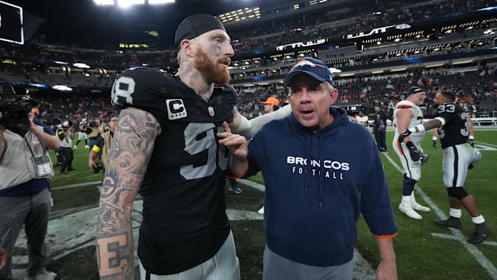 Las Vegas Raiders defensive end Maxx Crosby and Denver Broncos coach Sean Payton meet on the field.