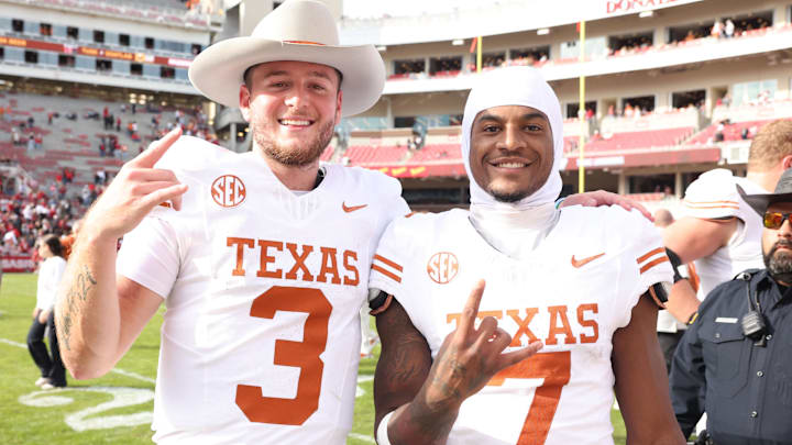 Nov 16, 2024; Fayetteville, Arkansas, USA; Texas Longhorns quarterback Quinn Ewers (3) and wide receiver Isaiah Bond (7) celebrate after the game against the Arkansas Razorbacks at Donald W. Reynolds Razorback Stadium. Texas won 20-10. Mandatory Credit: Nelson Chenault-Imagn Images