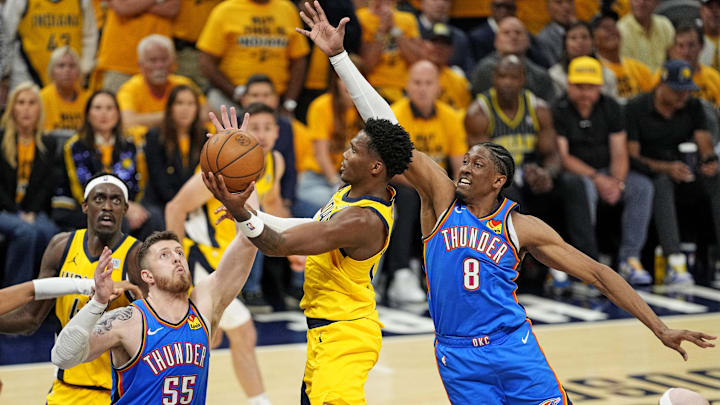 Jun 11, 2025; Indianapolis, Indiana, USA; Indiana Pacers guard Bennedict Mathurin (00) shoots the ball against Oklahoma City Thunder center Isaiah Hartenstein (55) and forward Jalen Williams (8) during the fourth quarter in game three of the 2025 NBA Finals at Gainbridge Fieldhouse. Mandatory Credit: Kyle Terada-Imagn Images