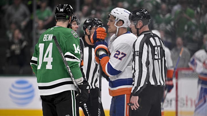 Nov 18, 2025; Dallas, Texas, USA; The NHL referees confer with Dallas Stars left wing Jamie Benn (14) and New York Islanders left wing Anders Lee (27) during the third period at the American Airlines Center. Mandatory Credit: Jerome Miron-Imagn Images
