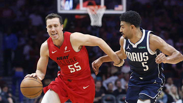 Nov 24, 2024; Miami, Florida, USA;  Dallas Mavericks guard Quentin Grimes (5) defends Miami Heat forward Duncan Robinson (55) during the first half  at Kaseya Center. Mandatory Credit: Rhona Wise-Imagn Images