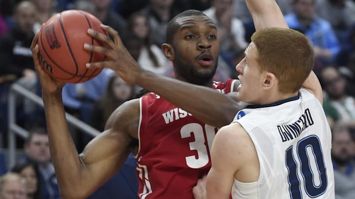 Mar 18, 2017; Buffalo, NY, USA; Wisconsin Badgers forward Vitto Brown (30) looks to pass against Villanova Wildcats guard Donte DiVincenzo (10) in the first half during the second round of the 2017 NCAA Tournament at KeyBank Center. Mandatory Credit: Mark Konezny-Imagn Images
