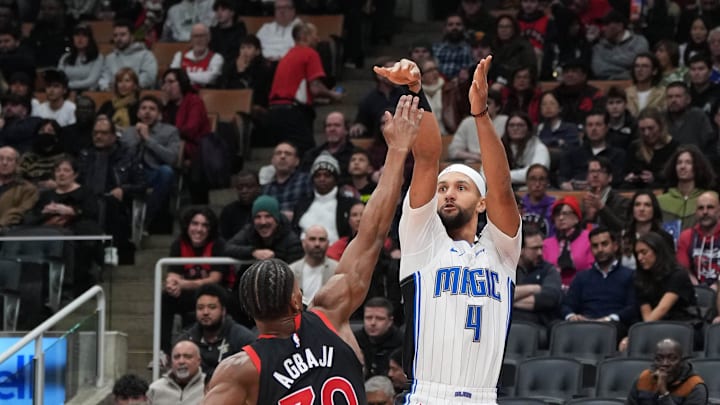 Orlando Magic guard Jalen Suggs (4) shoots against Toronto Raptors guard Ochai Agbaji (30) during the first quarter at Scotiabank Arena.