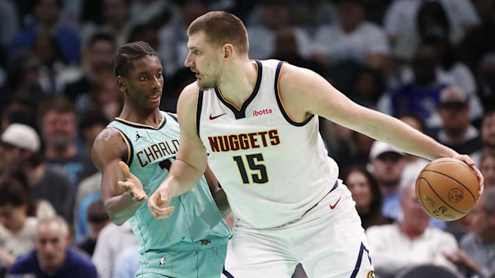Feb 1, 2025; Charlotte, North Carolina, USA; Denver Nuggets center Nikola Jokic (15) is defended by Charlotte Hornets forward Moussa Diabate (14) during the second half of play at Spectrum Center. Mandatory Credit: Brian Westerholt-Imagn Images
