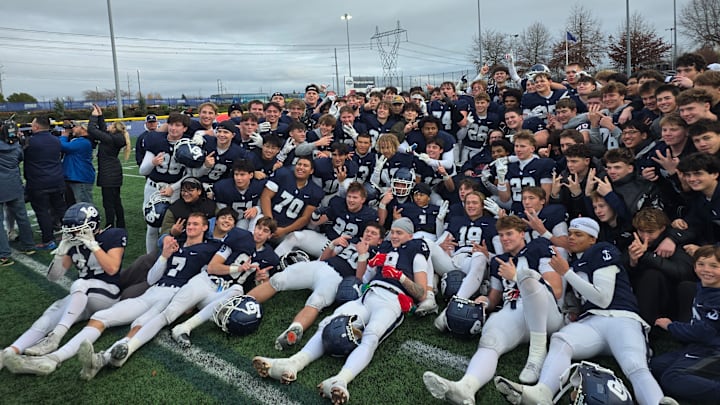 The Lake Oswego football team celebrates after winning the Class 6A state championship Friday afternoon.