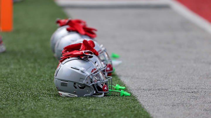 Aug 31, 2024; Columbus, Ohio, USA;  Ohio State Buckeyes helmets on the field before a game against the Akron Zips at Ohio Stadium. Mandatory Credit: Joseph Maiorana-Imagn Images