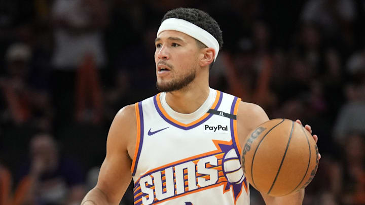 Apr 11, 2025; Phoenix, Arizona, USA; Phoenix Suns guard Devin Booker (1) dribbles against the San Antonio Spurs during the second half at Footprint Center. Mandatory Credit: Joe Camporeale-Imagn Images