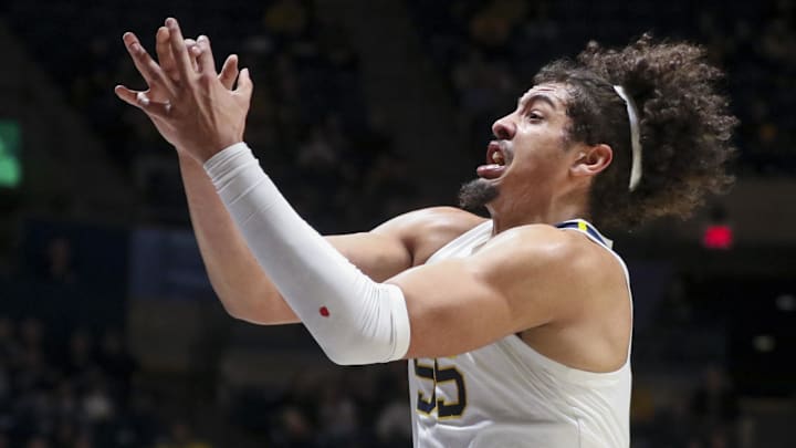 Jan 6, 2026; Morgantown, West Virginia, USA; West Virginia Mountaineers center Harlan Obioha (55) rebounds a ball during the first half against the Cincinnati Bearcats at Hope Coliseum. Mandatory Credit: Ben Queen-Imagn Images Jan 6, 2026; Morgantown, West Virginia, USA; West Virginia Mountaineers center Harlan Obioha (55) rebounds a ball during the first half against the Cincinnati Bearcats at Hope Coliseum. Mandatory Credit: Ben Queen-Imagn Images