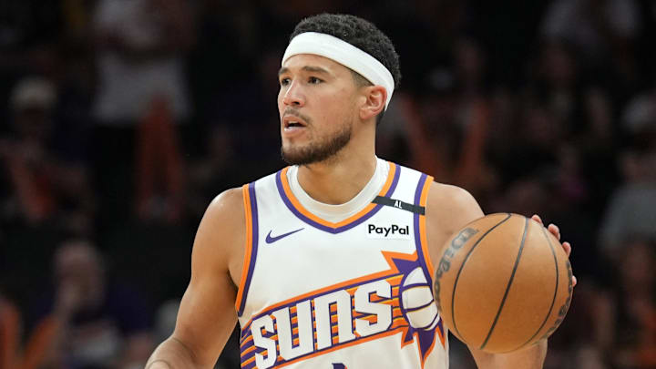 Apr 11, 2025; Phoenix, Arizona, USA; Phoenix Suns guard Devin Booker (1) dribbles against the San Antonio Spurs during the second half at Footprint Center. Mandatory Credit: Joe Camporeale-Imagn Images
