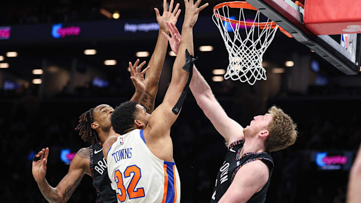 Mar 20, 2026; Brooklyn, New York, USA; New York Knicks center Karl-Anthony Towns (32) rebounds against Brooklyn Nets forward Danny Wolf (2) and center Nic Claxton (33) during the first quarter at Barclays Center. Mandatory Credit: Vincent Carchietta-Imagn Images Mar 20, 2026; Brooklyn, New York, USA; New York Knicks center Karl-Anthony Towns (32) rebounds against Brooklyn Nets forward Danny Wolf (2) and center Nic Claxton (33) during the first quarter at Barclays Center. Mandatory Credit: Vincent Carchietta-Imagn Images