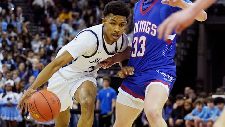 Nicolet's Davion Hannah (25) attempts to get pass Wisconsin Lutheran's Kon Knueppel (33) during the first half of the WIAA Division 2 boys basketball state semifinal game on Friday March 15, 2024 at the Kohl Center in Madison, Wis.