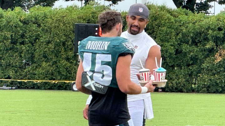 Eagles undrafted rookie receiver Taylor Morin delivers water ice to Jalen Hurts after a recent training camp practice. Eagles undrafted rookie receiver Taylor Morin delivers water ice to Jalen Hurts after a recent training camp practice.