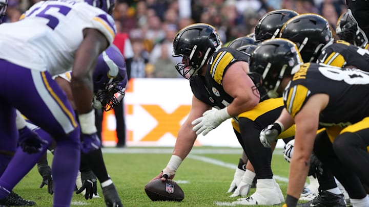 Sep 28, 2025; Dublin, Ireland; Helmets at the line of scrimmage as Pittsburgh Steelers center Zach Frazier (54) snaps the ball against the Minnesota Vikings in the fourth quarter during an NFL International Series game at Croke Park. Mandatory Credit: Kirby Lee-Imagn Images
