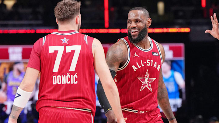 Feb 18, 2024; Indianapolis, Indiana, USA; Western Conference forward LeBron James (23) of the Los Angeles Lakers and forward Luka Doncic (77) of the Dallas Mavericks reacts after a play during the first half of the 73rd NBA All Star game at Gainbridge Fieldhouse. Mandatory Credit: Kyle Terada-Imagn Images Feb 18, 2024; Indianapolis, Indiana, USA; Western Conference forward LeBron James (23) of the Los Angeles Lakers and forward Luka Doncic (77) of the Dallas Mavericks reacts after a play during the first half of the 73rd NBA All Star game at Gainbridge Fieldhouse. Mandatory Credit: Kyle Terada-Imagn Images
