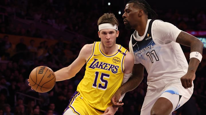  Los Angeles Lakers guard Austin Reaves (15) drives against Minnesota Timberwolves center Naz Reid (11) during the second quarter at Crypto.com Arena.