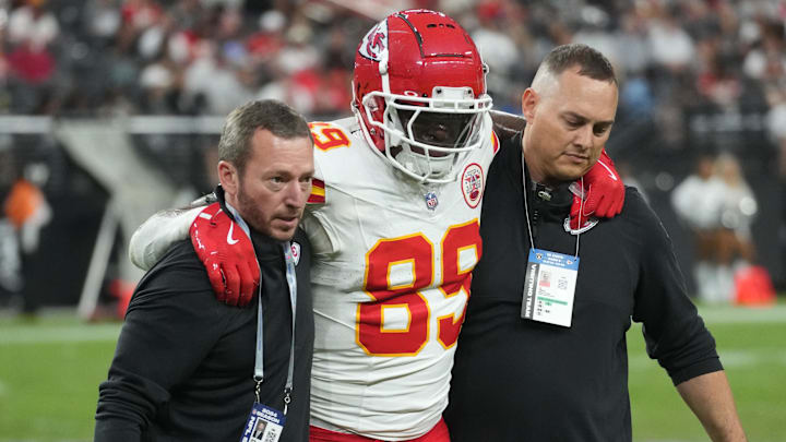 Oct 27, 2024; Paradise, Nevada, USA; Kansas City Chiefs tight end Jody Fortson (89) is assisted off the field after suffering an injury by John Paul Schroeppel (left) and Luke Thompson (right) in the second half against the Las Vegas Raiders at Allegiant Stadium. Mandatory Credit: Kirby Lee-Imagn Images Oct 27, 2024; Paradise, Nevada, USA; Kansas City Chiefs tight end Jody Fortson (89) is assisted off the field after suffering an injury by John Paul Schroeppel (left) and Luke Thompson (right) in the second half against the Las Vegas Raiders at Allegiant Stadium. Mandatory Credit: Kirby Lee-Imagn Images