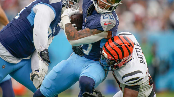 Tennessee Titans running back Tony Pollard (20) is stopped by Cincinnati Bengals safety Jordan Battle (27) during the third quarter at Nissan Stadium in Nashville, Tenn., Sunday, Dec. 15, 2024.
