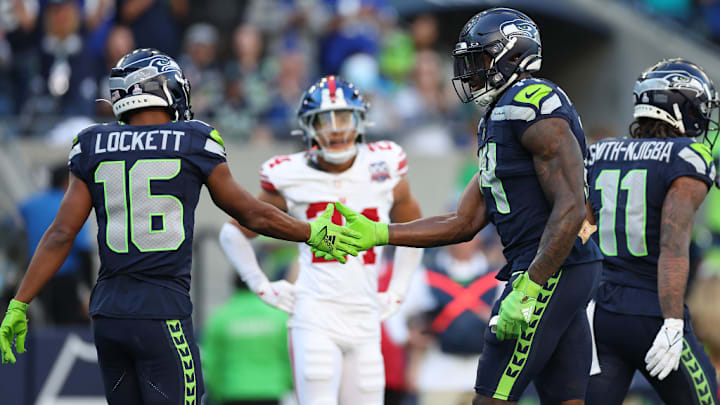 SEATTLE, WASHINGTON - OCTOBER 06: Tyler Lockett #16 and DK Metcalf #14 of the Seattle Seahawks react during the fourth quarter against the New York Giants at Lumen Field on October 06, 2024 in Seattle, Washington.